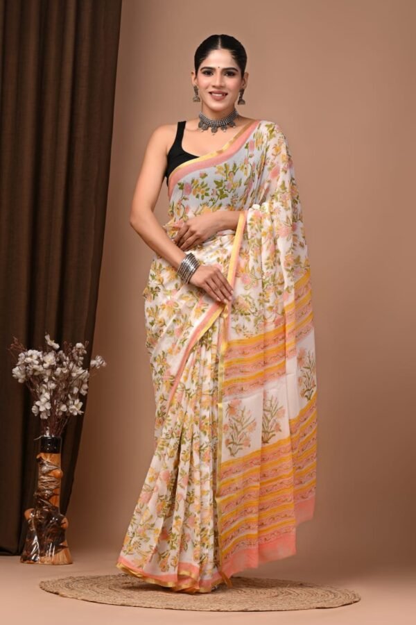 Woman in cream floral hand block printed chiffon saree with striped gold border