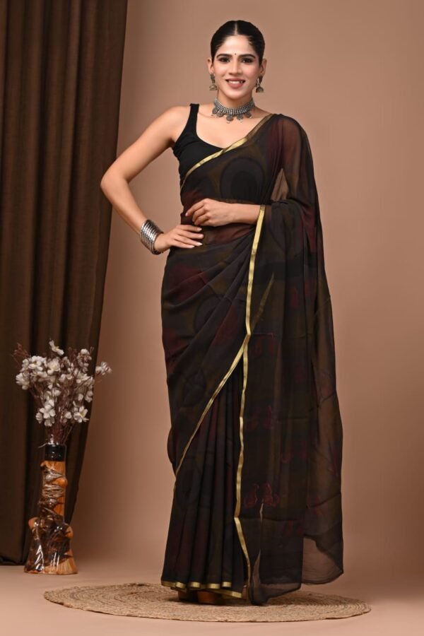 Woman draped in black-brown hand block printed double diamond chiffon saree with gold border