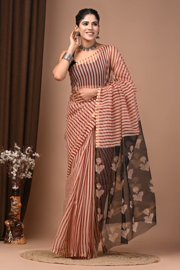 Woman wearing rust striped Kota Doria cotton saree with black floral print pallu