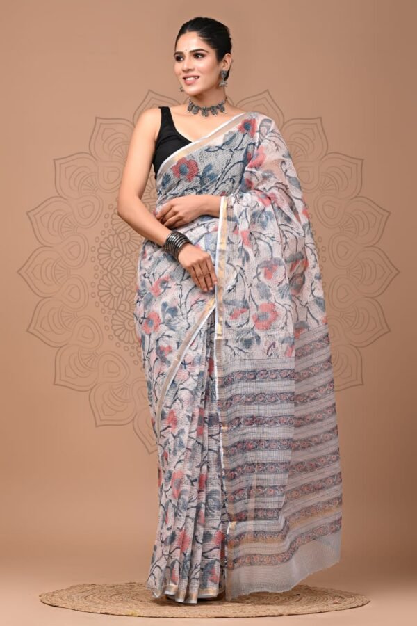Woman draped in off-white Kota Doria cotton saree with coral floral hand block print and gold border