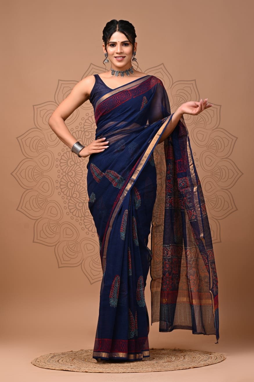 Woman draped in navy blue Kota Doria cotton saree with rust leaf booti print and golden border