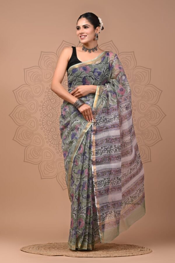 Woman draped in sage green Kota Doria cotton saree with floral print and golden border