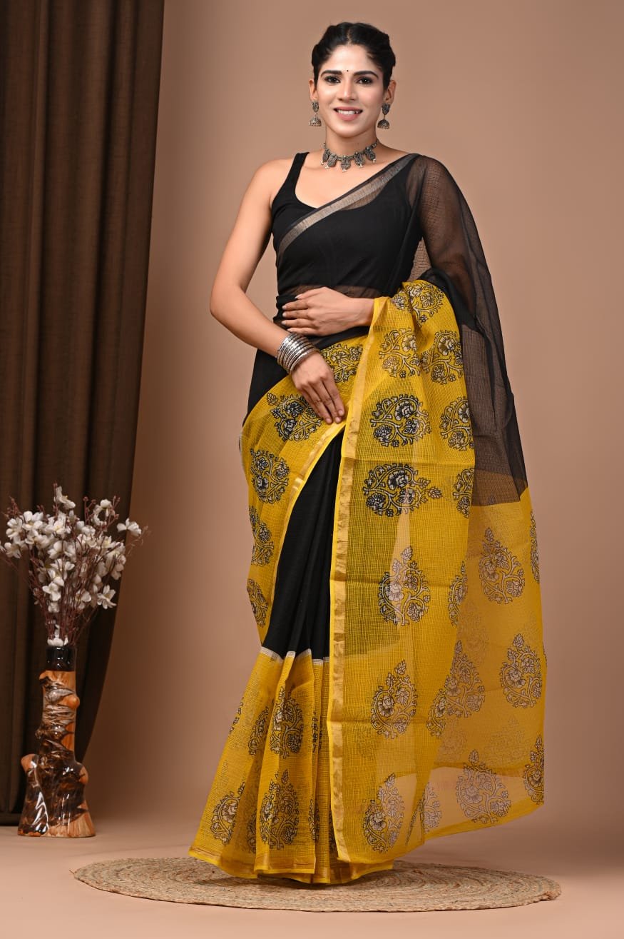 Woman wearing black Kota Doria cotton saree with mustard yellow paisley print border and pallu