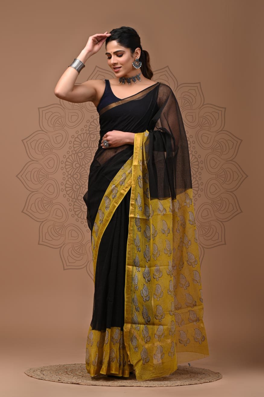 Woman draped in black Kota Doria cotton saree with mustard yellow paisley print pallu and border