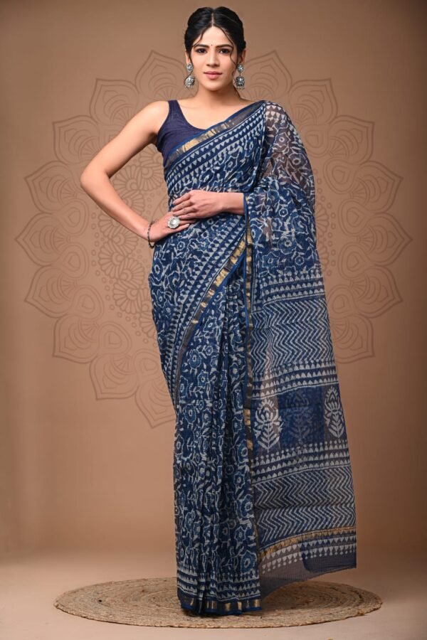 Woman wearing navy blue hand block printed Kota Doria cotton saree with white floral and zigzag pattern