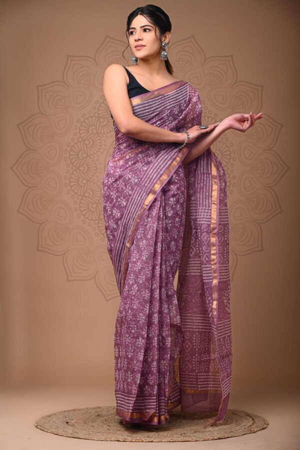 Woman wearing mauve purple hand block printed Kota Doria cotton saree with floral booti pattern