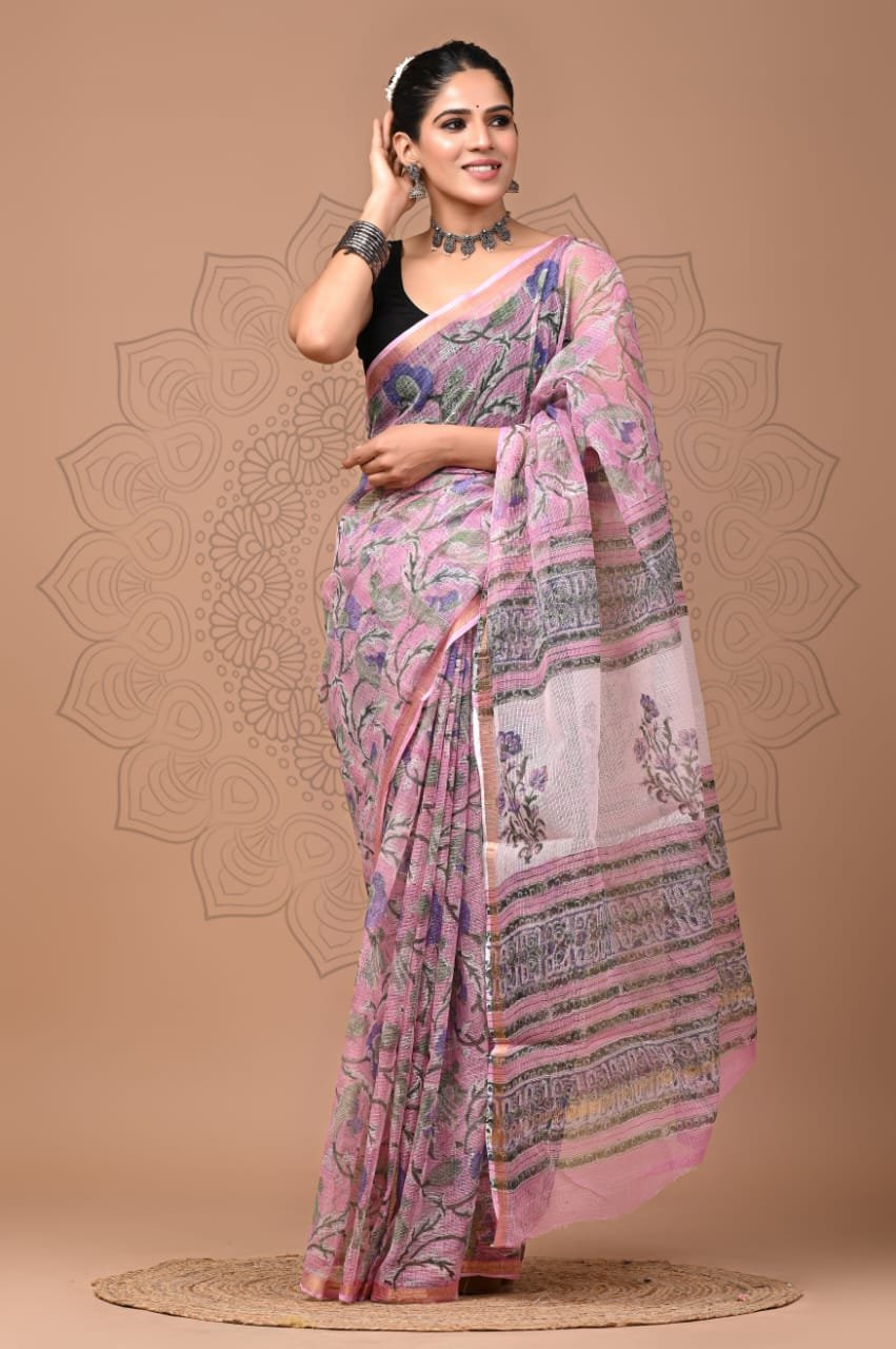 Woman wearing pink floral hand block printed Kota Doria cotton saree with striped pallu border