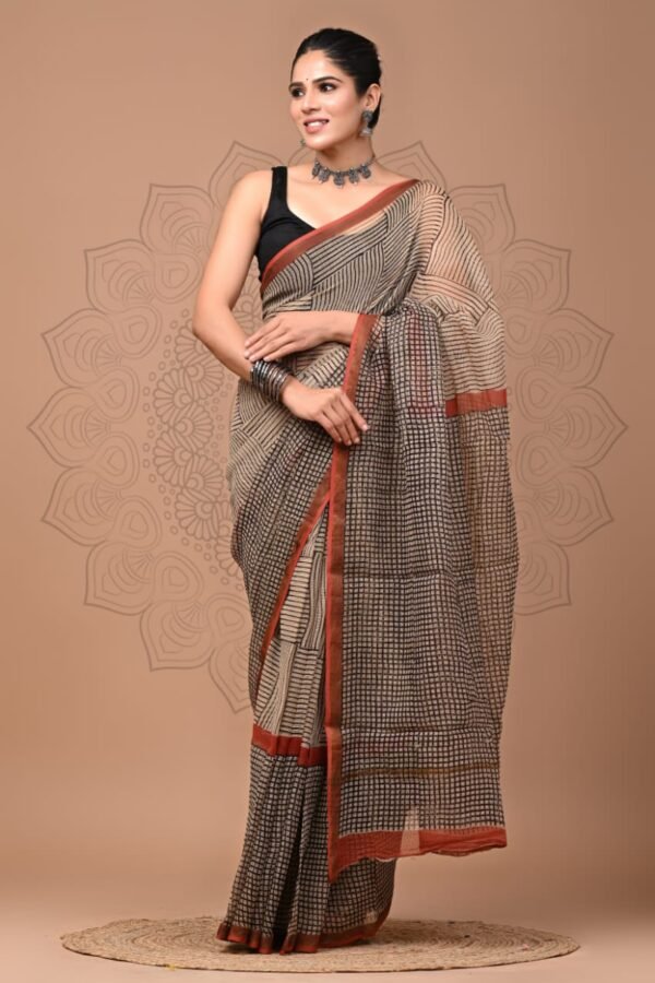 Woman wearing beige and black checkered hand block printed Kota Doria cotton saree with rust border