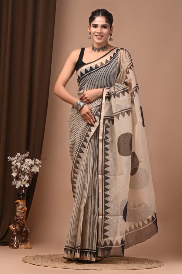 Woman draped in grey striped hand block printed Kota Doria cotton saree with black zigzag border