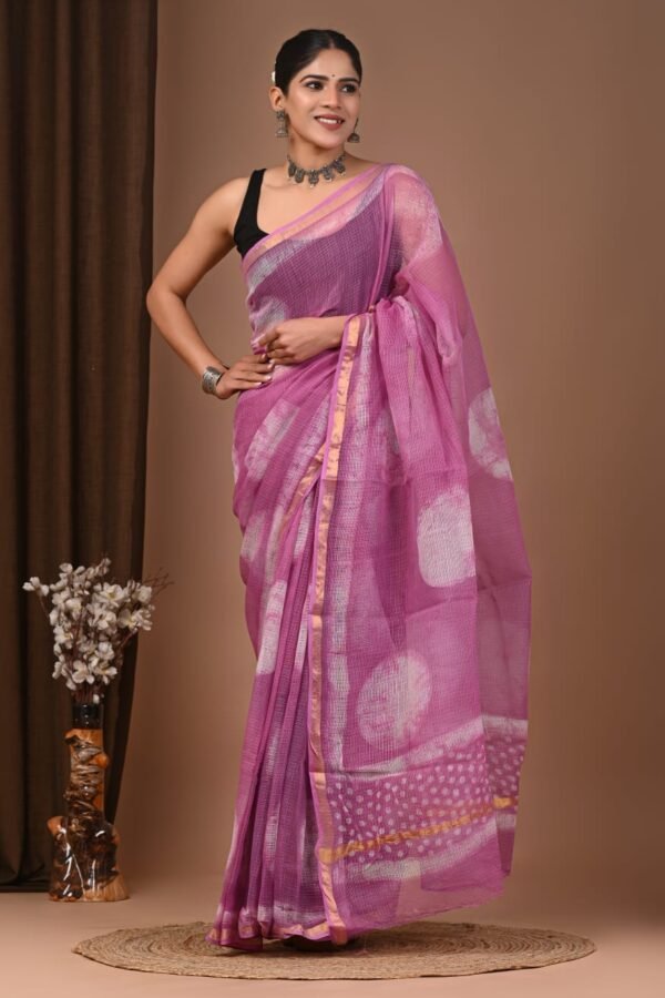Woman wearing mauve-pink hand block printed Kota Doria cotton saree with circle motifs
