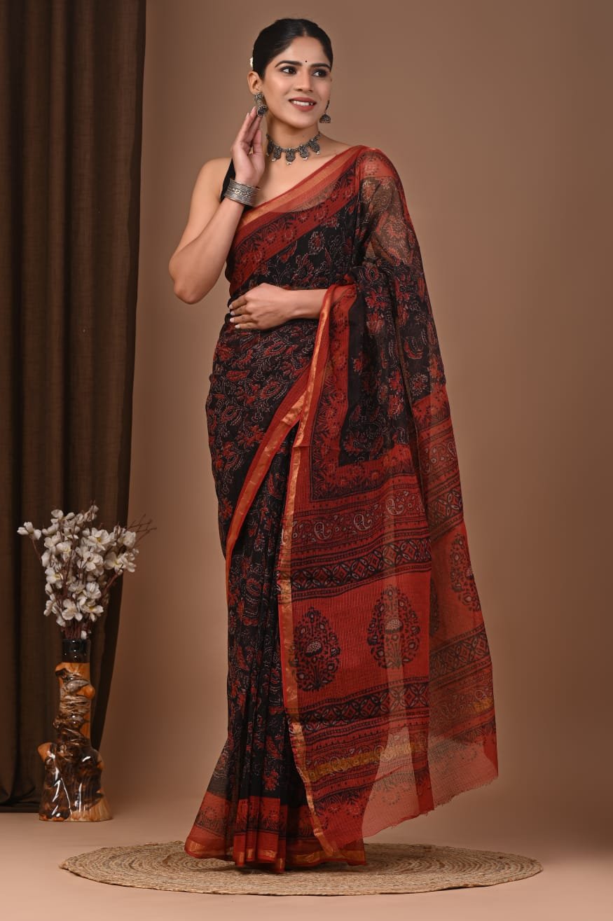 Woman wearing black and rust-red floral hand block printed Kota Doria cotton saree with golden border