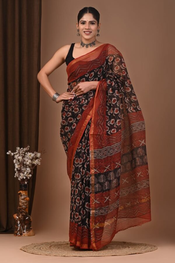 Woman wearing black and rust floral hand block printed Kota Doria cotton saree with geometric border