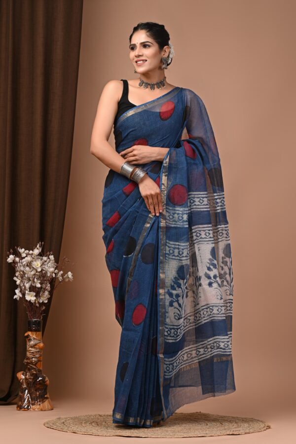 Woman wearing teal blue hand block printed Kota Doria cotton saree with polka dots and floral pallu