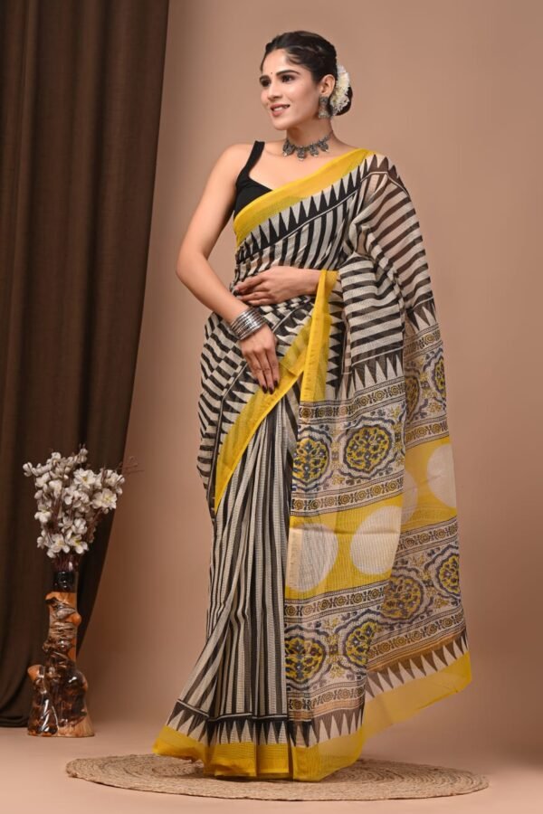 Woman wearing black and white striped hand block printed Kota Doria cotton saree with yellow border