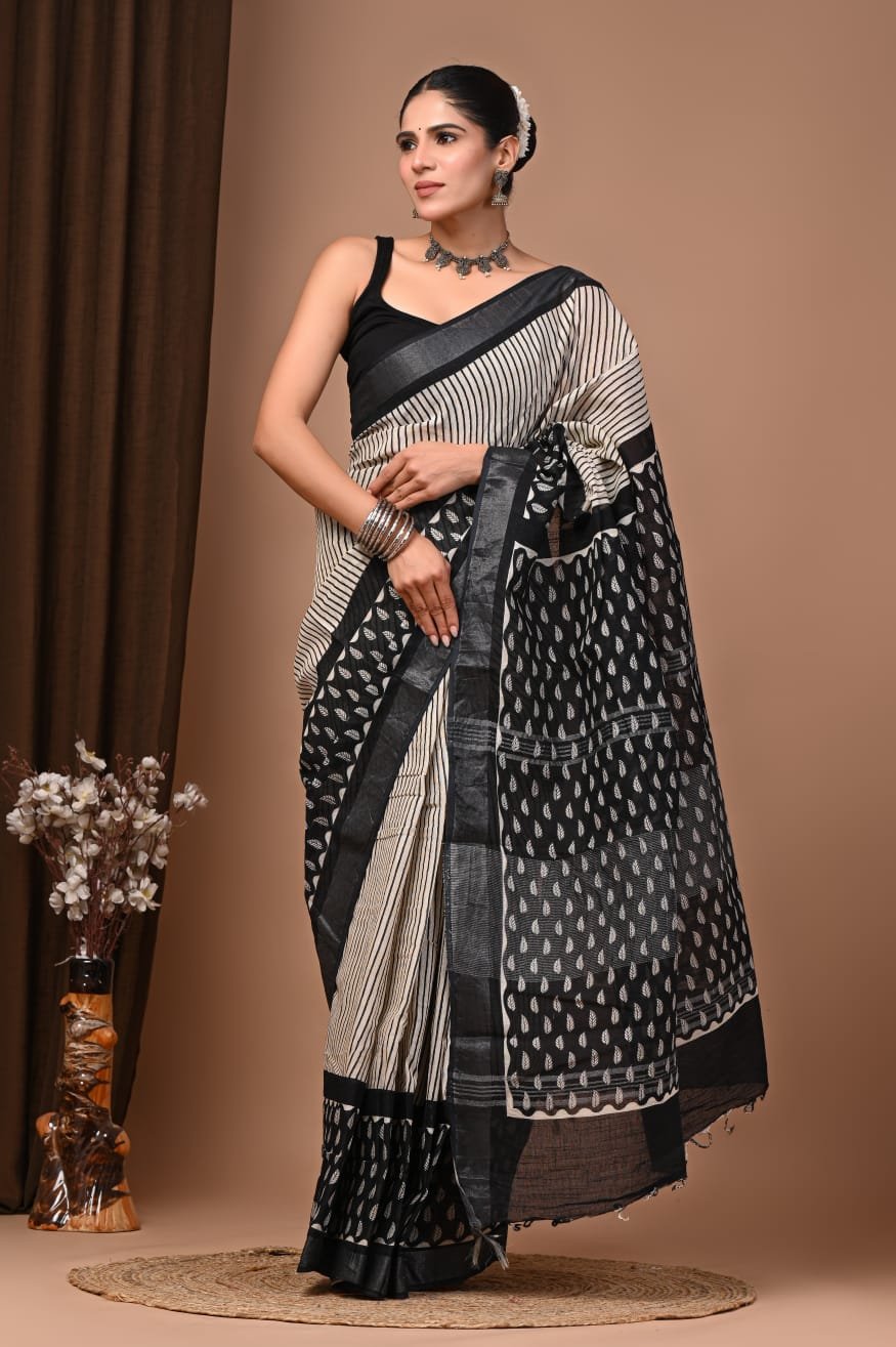 Woman wearing black and cream hand block printed linen cotton saree with paisley pallu