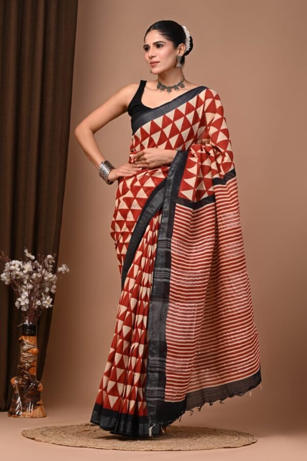 Woman in rust and cream hand block printed linen cotton saree with triangle pattern and black border