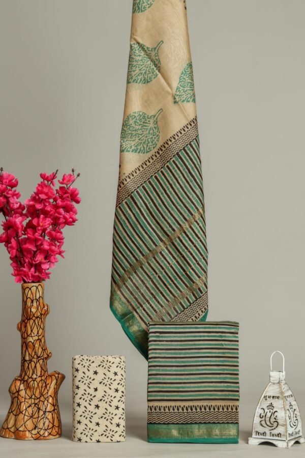 Beige Maheshwari silk suit with green leaf print and striped zari border, folded pieces alongside