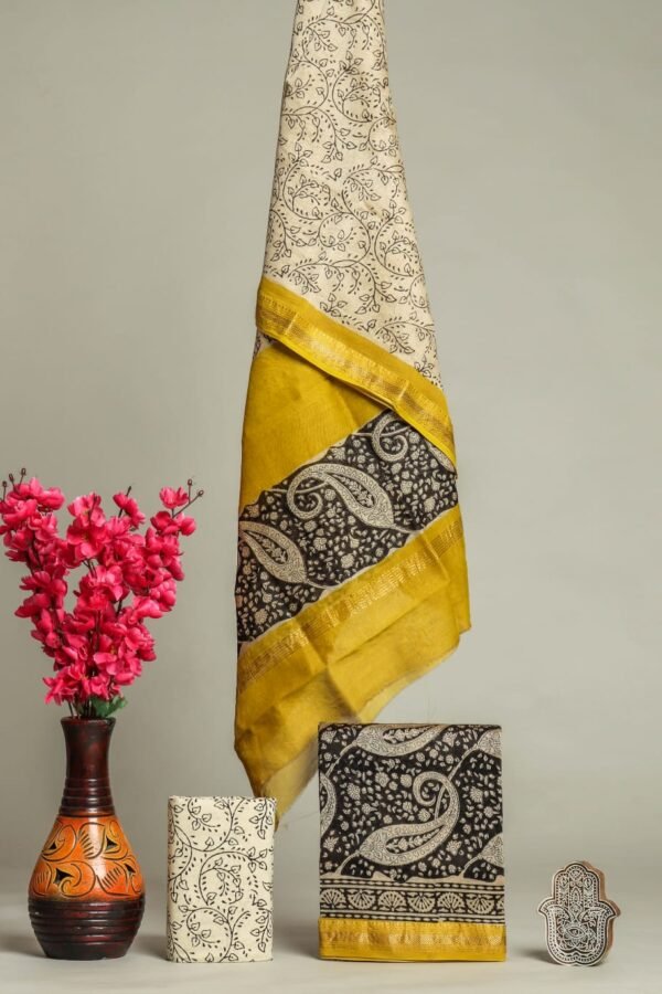 Cream and black Maheshwari silk suit with paisley block print and mustard zari border, folded pieces shown