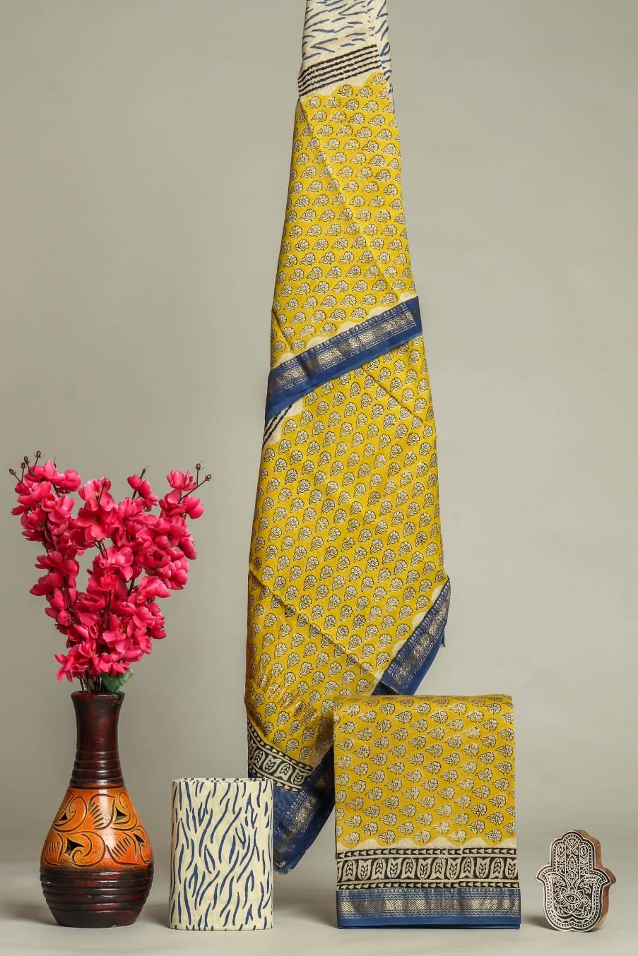 Mustard yellow Maheshwari silk suit with paisley booti block print and navy border draped display