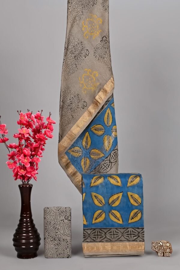 Grey Maheshwari silk suit with medallion print draped beside blue leaf lattice block print dress material