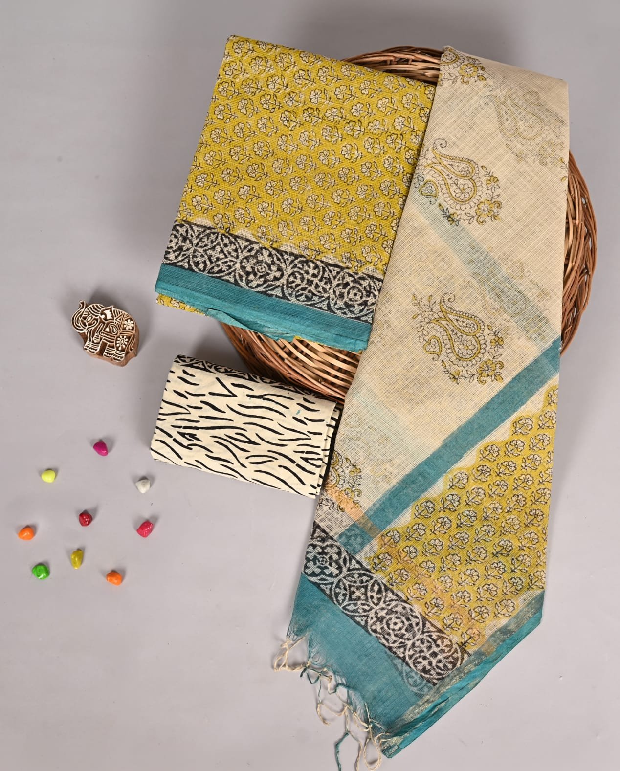 Mustard yellow floral print Kota Doria suit fabric with cream paisley dupatta and zebra print fabric piece