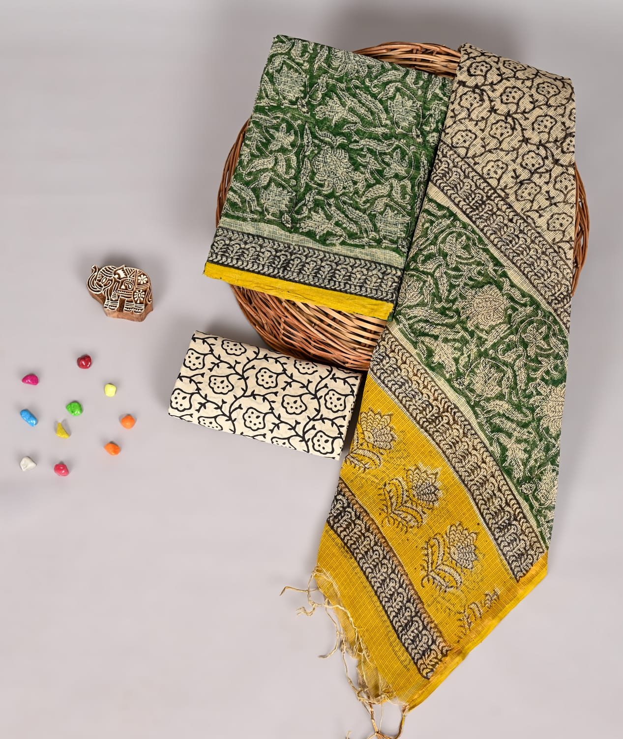 Bottle green floral print Kota Doria suit fabric with mustard yellow bordered dupatta and cream fabric piece