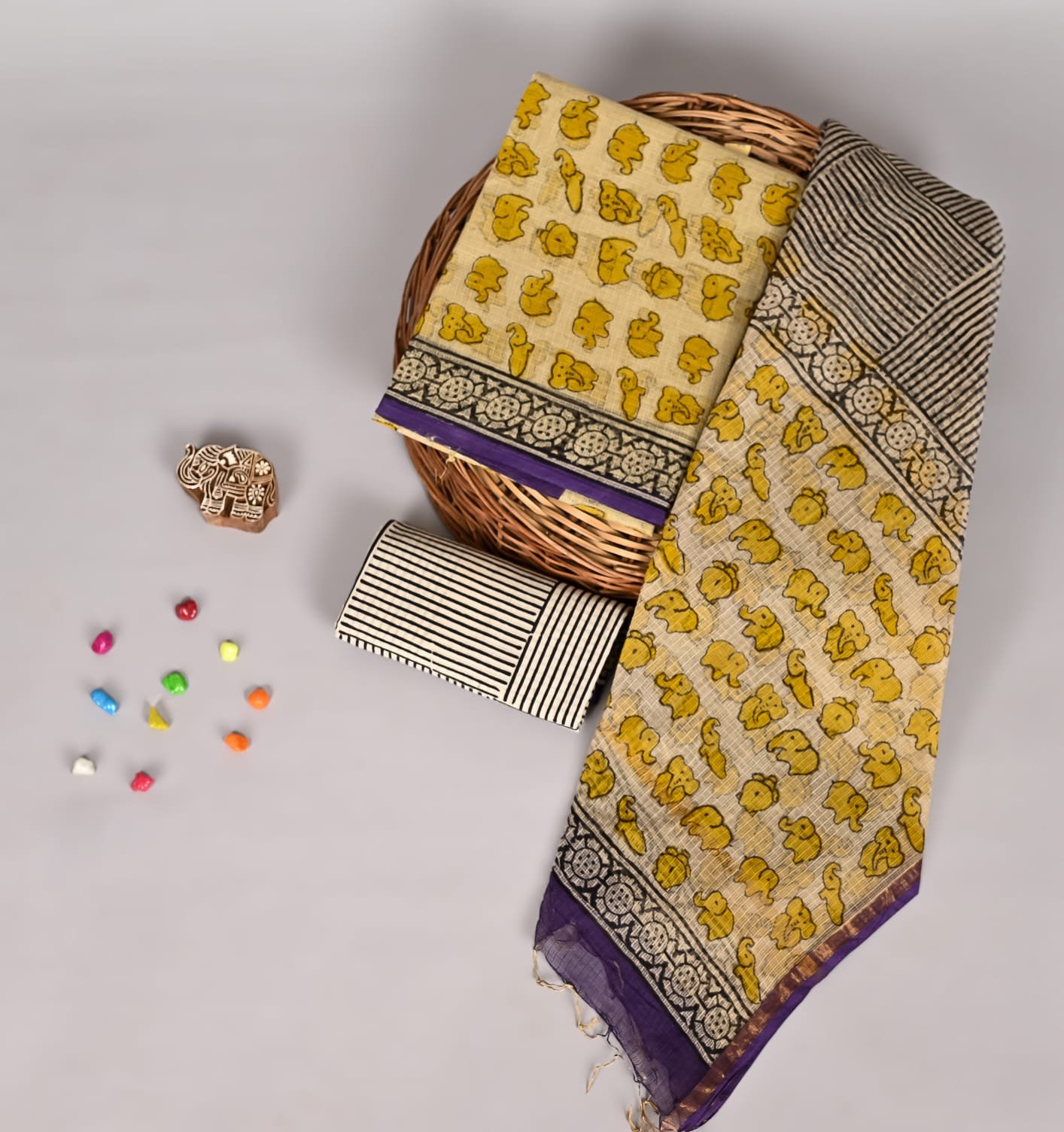 Mustard yellow elephant print Kota Doria suit fabric with black striped piece and purple border