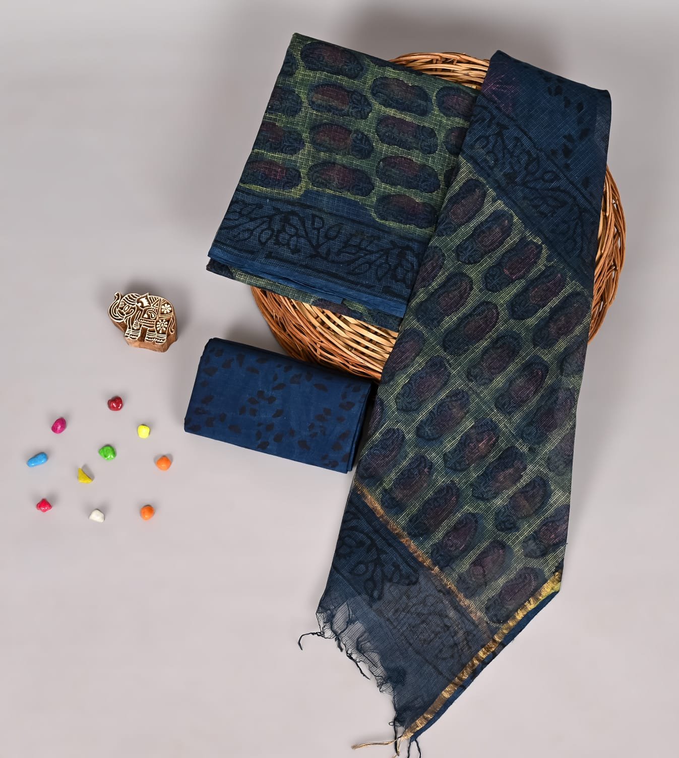 Olive green Kota Doria suit with navy oval print, floral border, and solid navy dupatta piece