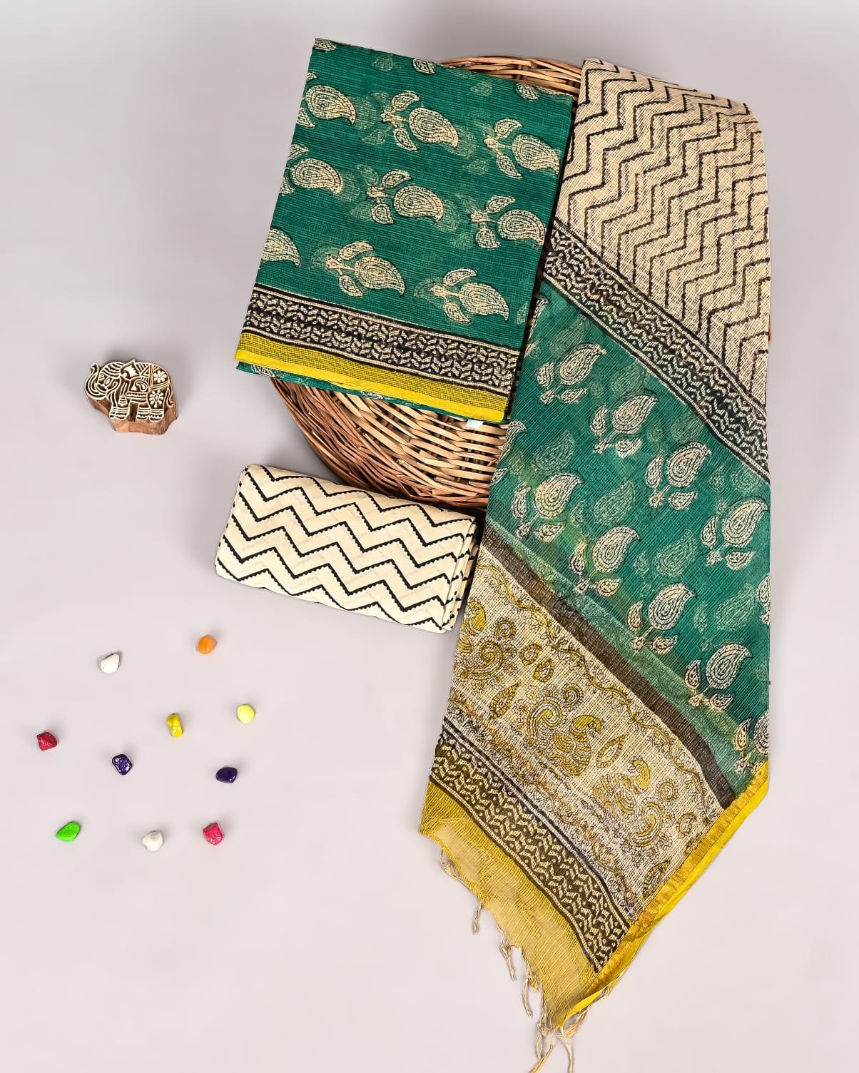 Teal green Kota Doria suit set with paisley print and zigzag chevron border, cream piece and dupatta