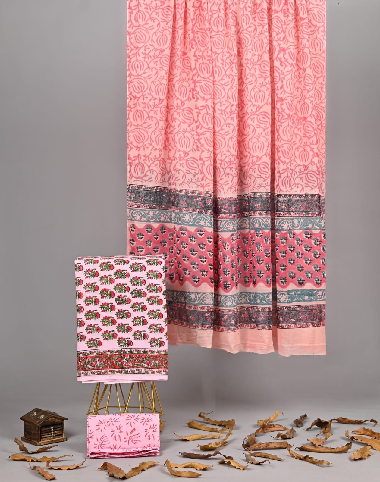 Peach hand block printed cotton dupatta with floral border, folded suit and bottom fabric alongside